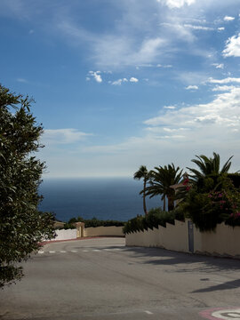 Cumbre del Sol-Adelfas, 1S, 03726 Benitachell, Alicante, Spain.
October 20, 2025.
Beautiful landscape with palm trees at sunset overlooking the blue, palm trees on the beach