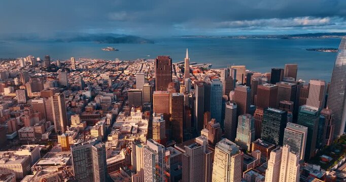 Grey cloudscape covered the sky over downtown San Francisco, California, USA. Flight through the clouds approaching the Transamerica Pyramid Tower.