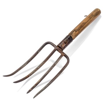 An aged, rusty, garden pitchfork with wooden handle cast in a shadow