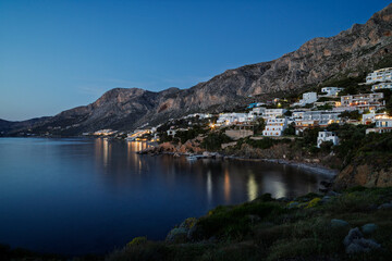 Mountainous and rugged landscape, coastline and the Aegean Sea towards the village of Masouri (Massouri) on Kalymnos island in Greece at dusk.