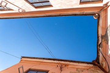 Low-angle upward view of sky framed by old European building