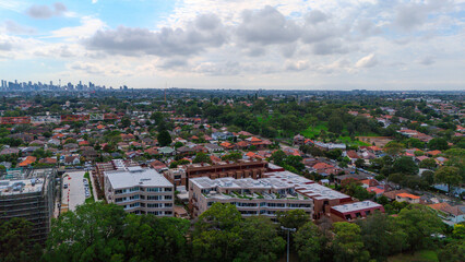 Panoramic Aerial Drone view of Inner Western Suburbs of Sydney housing, roof tops, the streets and the parks, the roads and trees of Ashbury Ashfield Burwood Summer Hill Canterbury and Campsie in Sydn