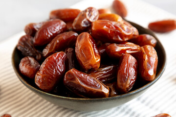 Organic Raw Dry Dates in a Bowl, side view. Close-up.