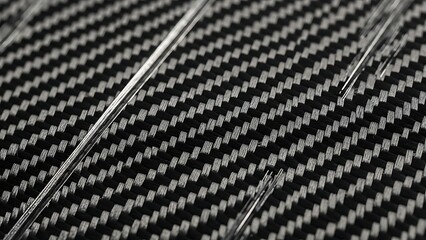 Close up of carbon fiber weave with thin wires