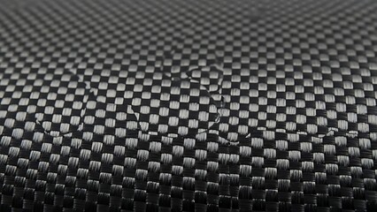 Grayscale close up of carbon fiber weave texture