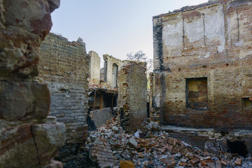 Fototapeta premium Ruins of a city квартал after fire with destroyed houses, charred materials and debris everywhere. Dramatic background representing crisis and catastrophe.