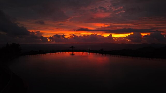 A beautiful and cinematic view of the Nglanggeran reservoir at sunset. An artificial lake for irrigation and a popular tourist destination for enjoying the hilly scenery.