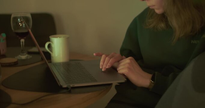 Female freelancer using laptop while working remotely at home