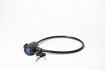 Fototapeta premium Close-up of black disc brake lock with reminder cable and keys on white background