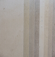 Fototapeta premium Stone tile samples displaying textured and smooth finishes, a neutral color palette for construction and interior design materials