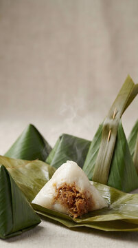 Traditional Thai sticky rice dessert wrapped in banana leaves with sweet coconut filling.