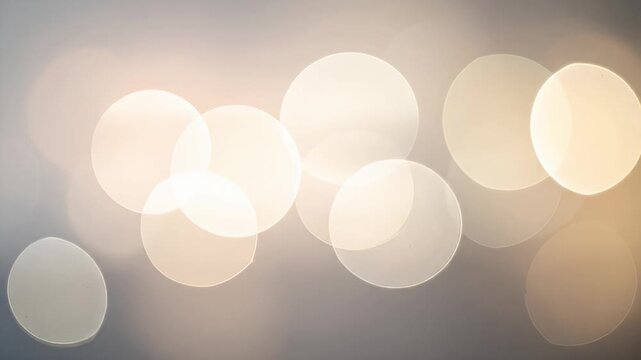 Abstract bokeh lights on gradient gray background create a soft, blurry effect