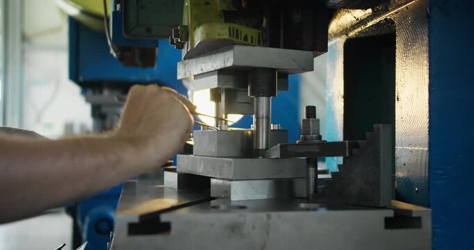 Mechanical stamping press detail, close view of press mold used in industrial manufacturing and factory production lines