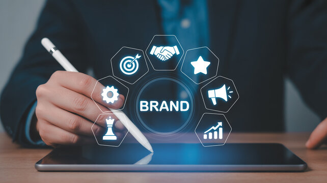 Businessman using a stylus on a tablet with a brand strategy icon circle branding marketing