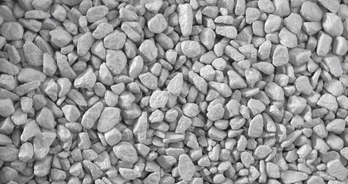 Rotation of Gray Gravel Texture. Seamless loop featuring a dense field of matte irregular pebbles in subtle continuous rotation around the central axis.