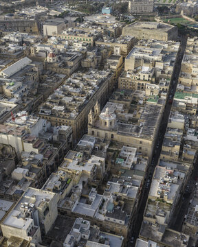 Aerial view of sun-drenched streets and historic buildings reveal the architectural grandeur of Valletta, Malta, creating a captivating tapestry of urban beauty., Valletta, Valletta, Malta.