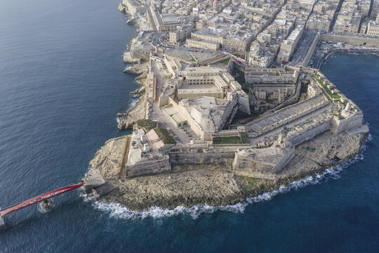 Aerial view of the imposing Fort Saint Elmo, a bastion of history against the azure sea, stands proudly, its stone walls a testament to time, Valletta, Valletta, Malta.