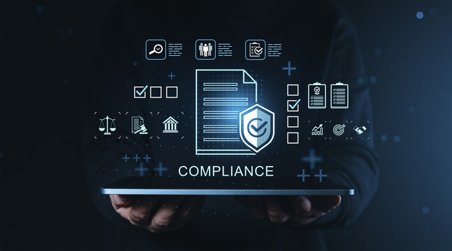 Compliance management concept with document and security icons floating above digital tablet held in hands on dark blue business background.