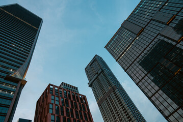 Obraz premium tall skyscrapers buildings looking up perspective, downtown district modern architecture of steel and glass, skyline of big city, low angle look-up view