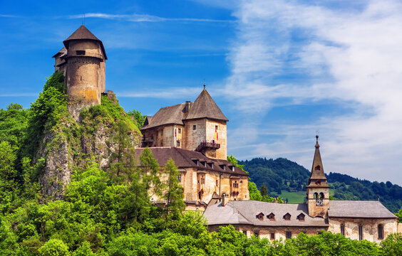 &bdquo;Orava Castle in Slovakia at night, famous filming location of the 1922 silent horror film Nosferatu. Dramatic gothic medieval castle on a rocky cliff with dark mysterious atmosphere.&ldquo;