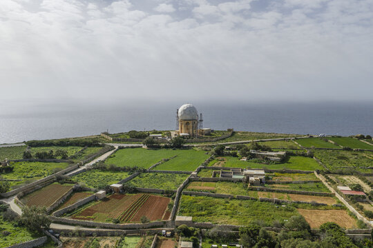 Aerial view of the iconic Dingli Radar Station perched on the cliffs, overlooking the vast expanse of the Mediterranean Sea, Dingli, Malta.