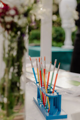 Vibrant Paintbrushes Await Artistic Expression at a Garden Party: Inspiring Creativity, Ready for Painting Projects and Celebrating Art in a Floral Setting