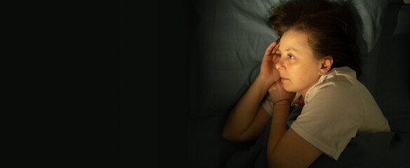 Concept of sleep disorder, insomnia and mental health. woman lying with open eyes on bed awake at...