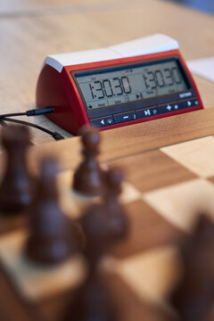 Chessboard in front, focused on a chess clock 