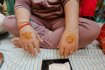 Woman Sit Cross-Legged with Henna Tattoo on Hands: Cultural Tradition, Celebration, Beauty, Artistic Expression and Decorative Body Art for Festivities