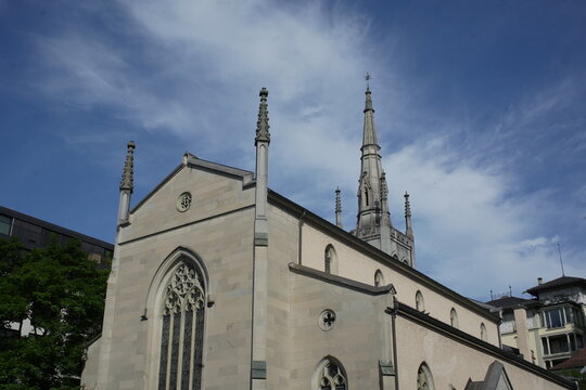 Exterior view of the Evangelical Reformed Church in Lucerne, Switzerland, showing the historic architecture, tower, and surrounding urban environment. 
