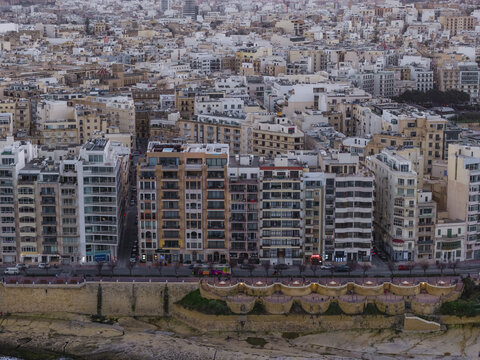 Aerial view of the urban landscape, where buildings meet the sea's edge in a mesmerizing blend of architectural styles, Sliema, Malta.