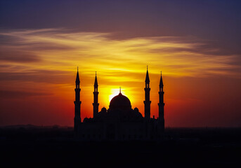 Majestic Silhouette of Mosque Against Dramatic Sunset Sky with Minarets