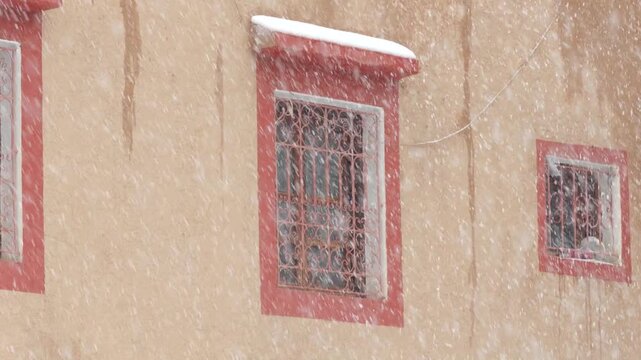 Traditional Moroccan window from Imlil town during a swon storm. Toubkal National Parc.