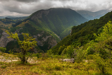 Lush green mountains forming a dramatic valley in Bosnia and Herzegovina.