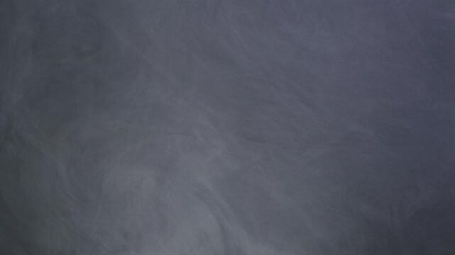 Gray Mist on Dark Backdrop. Footage depicting vapor emerging from shadows, forming transient shapes before dissolving into obscurity with gradual shifts