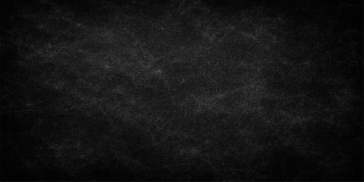 A dark and aged black paper texture background with a rough grunge pattern and vintage gray surface creates a blank chalkboard backdrop for a textured wall design