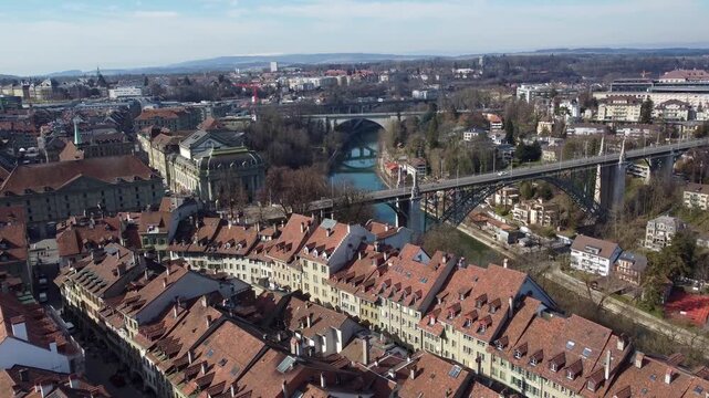 Bern, Switzerland: Aerial drone footage of the Bernold bridge over the Aar river  in Bern historic and city center in Switzerland on a sunny winter day. 
