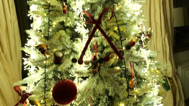 style warmly lit christmas tree inside polish countryside home glowing dense fairy lights frosted branches red ribbon bows handcrafted up close drone poland ornaments curtains mini 