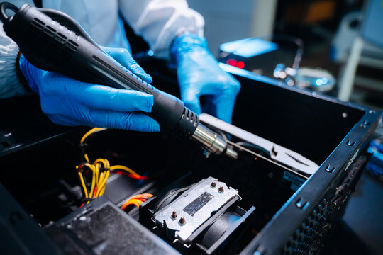 Technician installing graphics card inside desktop PC. Computer hardware upgrade, motherboard wiring, IT repair service and technology