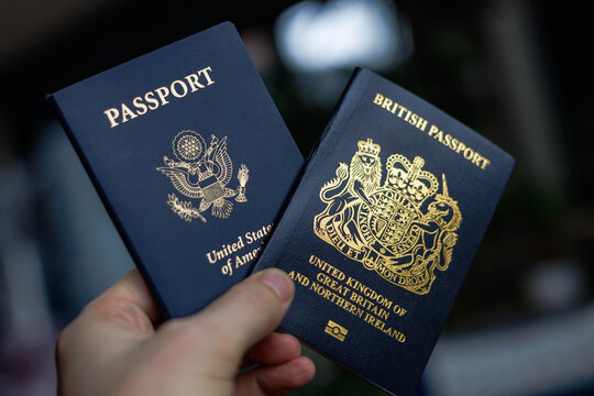 A close-up lifestyle image featuring a British and American passport placed side by side, symbolising dual citizenship