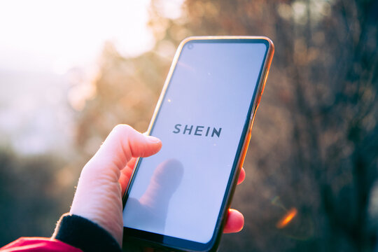 person opening shein app on a phone