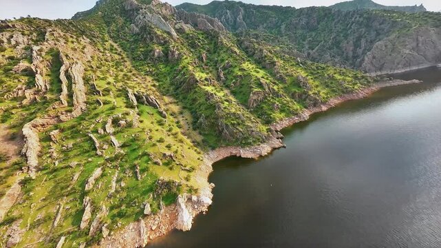 Cinematic FPV drone footage over Kermanshah, Iran  dynamic aerial view of urban landscape and surrounding mountains in golden hour light.