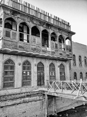 Historic two-story brick building with wooden balcony
