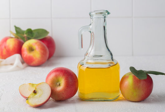 Red tasty apples and apple cider vinegar