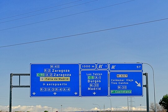 Road sign on the M-40 ring road in Madrid, Spain, indicating exit 1 towards Burgos and exit 57 towards Colmenar Viejo and Tres Cantos. February 14, 2026