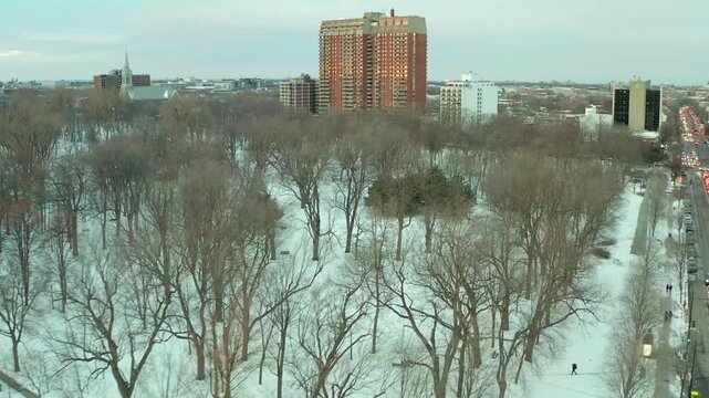 drone coming from street to park la fontaine in montreal in winter overlooking everything