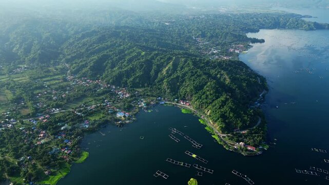 Smooth drone footage showing Agoncillo Laurel, Batangas Philippines hillside roads and tiny homes surrounded by lush terrain under daylight. Great for travel, tourism, and documentary use.