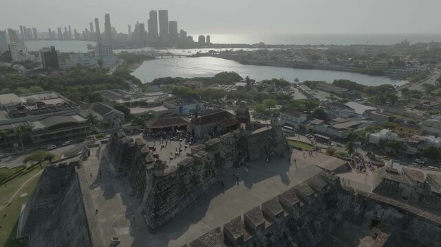 drone flying on top of main tower in castillo de san felipe cartagena n overlooking the sea the front of the castle n estatue during the day