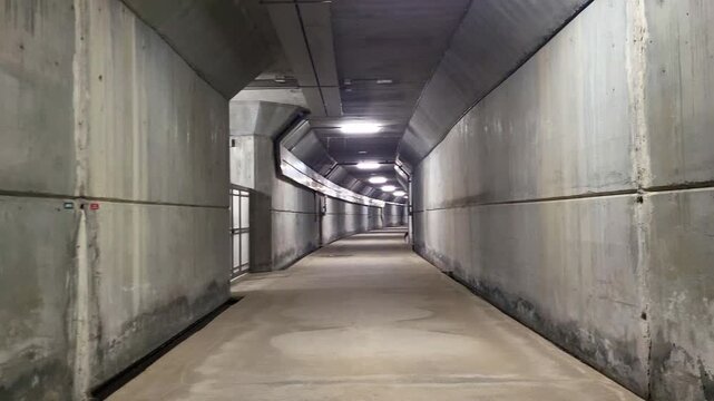 Service tunnel inside a gravity dam. Electrical installations, road access inside the dam. Access to maintenance galleries of a large reinforced concrete dam. Spain.