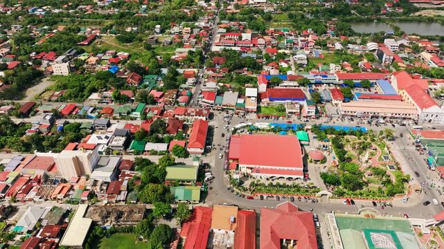 Aerial top-down view of Lingayen town square with colorful rooftops, traffic